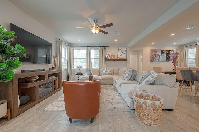 23611 Blackhaw Blossom Ln, Katy, TX 77493 - living area featuring a ceiling fan, visible vents, and light wood finished floors