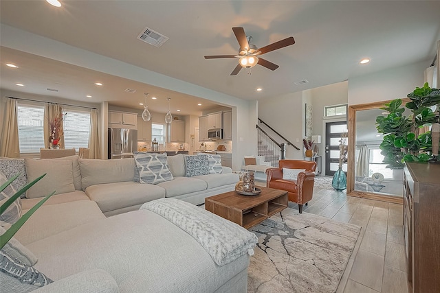 23611 Blackhaw Blossom Ln, Katy, TX 77493 - living area featuring stairs, plenty of natural light, recessed lighting, a ceiling fan, and light wood-style floors