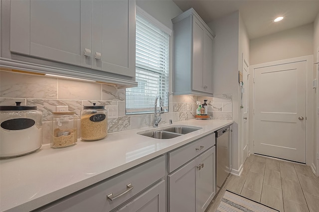 23611 Blackhaw Blossom Ln, Katy, TX 77493 - kitchen with stainless steel dishwasher, recessed lighting, light countertops, tasteful backsplash, and a sink