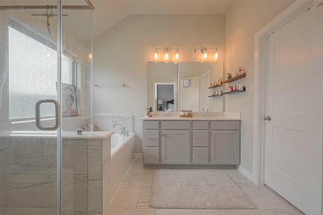 23611 Blackhaw Blossom Ln, Katy, TX 77493 - full bath featuring marble look tile flooring, a garden tub, double vanity, a shower stall, and lofted ceiling