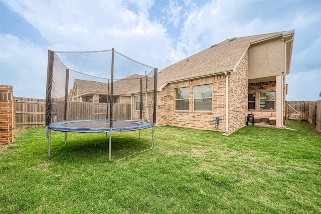 23611 Blackhaw Blossom Ln, Katy, TX 77493 - fenced backyard featuring a trampoline and an outdoor living space