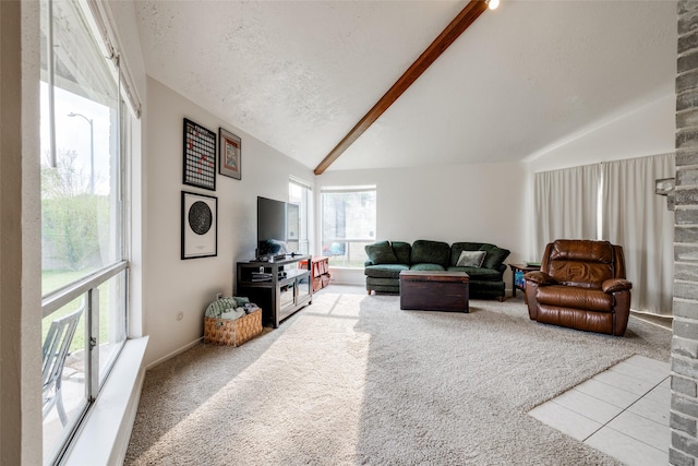 carpeted living room featuring vaulted ceiling with beams and a textured ceiling