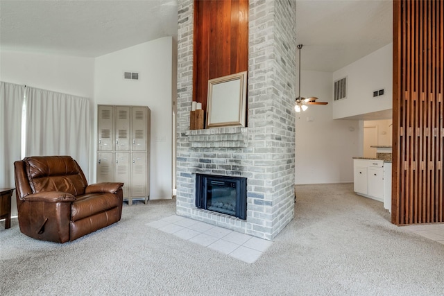 living room with light colored carpet, visible vents, and high vaulted ceiling