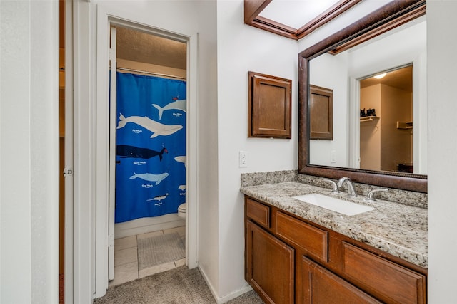 bathroom with vanity, toilet, tile patterned floors, baseboards, and a shower with curtain