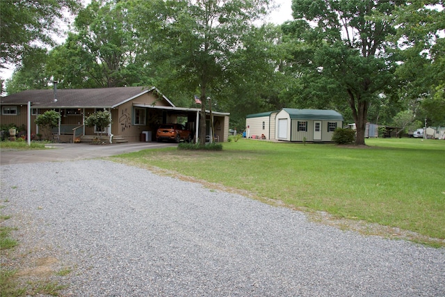 view of front of house with an outdoor structure, a front lawn, aphalt driveway, and a shed