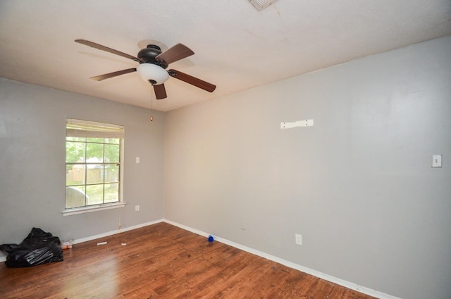 unfurnished room featuring baseboards, ceiling fan, and wood finished floors