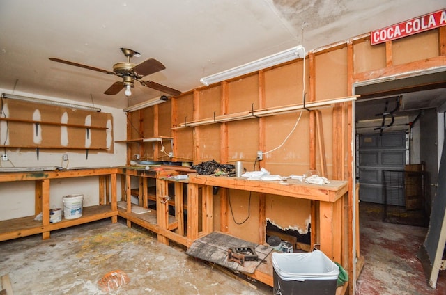 below grade area with a ceiling fan
