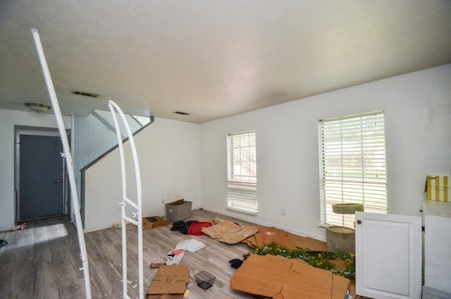 interior space featuring visible vents, baseboards, and wood finished floors