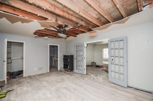 basement with french doors and ceiling fan