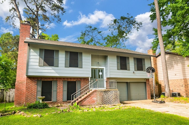 bi-level home featuring brick siding, central AC unit, a garage, and a chimney