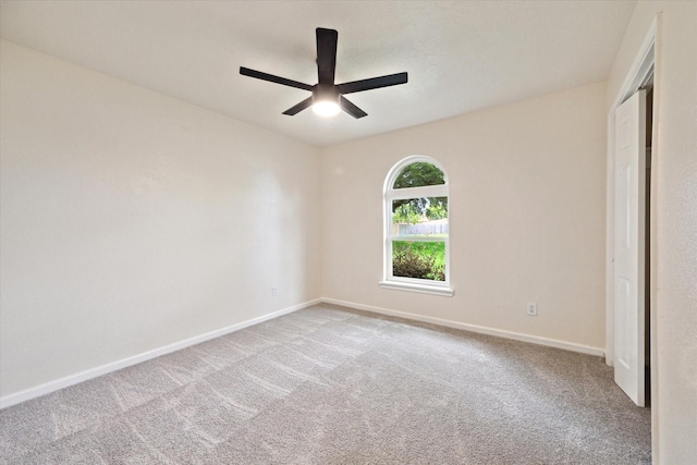 unfurnished room with baseboards, ceiling fan, and carpet floors