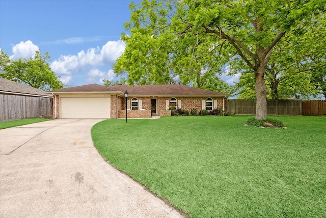 ranch-style house with fence, an attached garage, a front lawn, brick siding, and concrete driveway