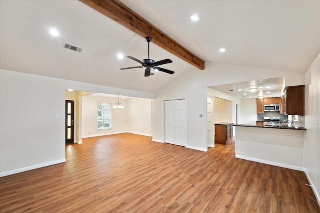 unfurnished living room with recessed lighting, visible vents, light wood finished floors, and ceiling fan with notable chandelier