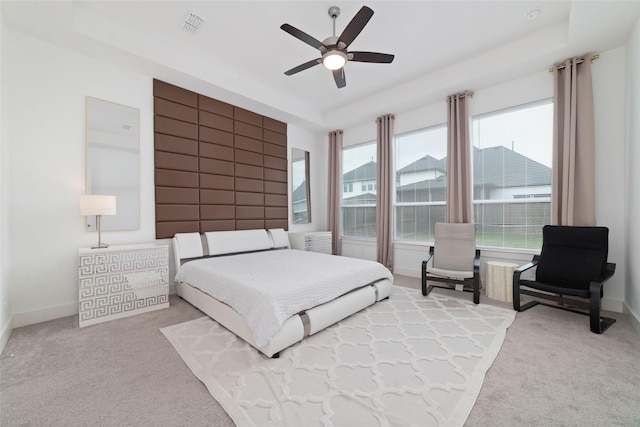bedroom featuring carpet flooring, visible vents, and multiple windows