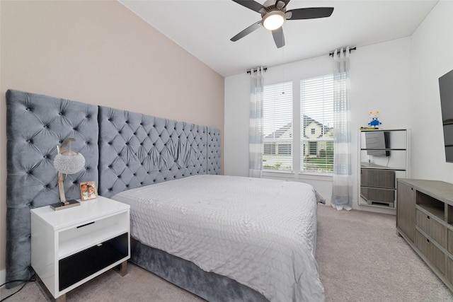bedroom with ceiling fan and light carpet