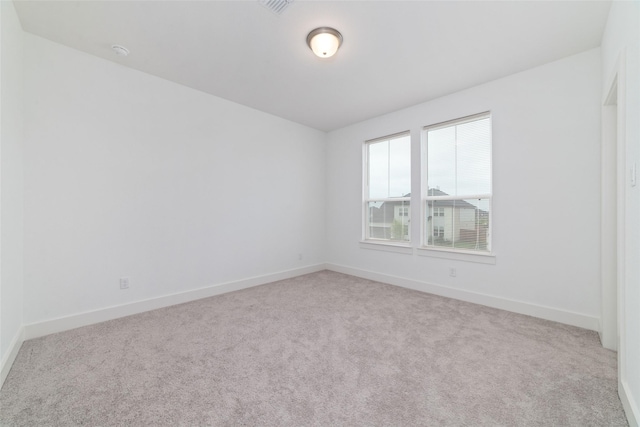 unfurnished room featuring carpet floors, baseboards, and visible vents