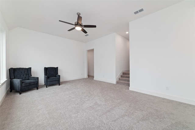 unfurnished room featuring a ceiling fan, visible vents, stairway, baseboards, and carpet