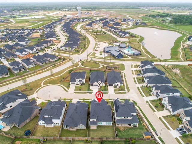 drone / aerial view with a water view and a residential view