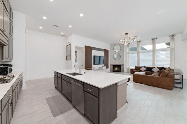 kitchen with light countertops, a sink, visible vents, and stainless steel appliances