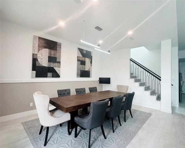 dining area featuring recessed lighting, baseboards, stairs, and wood finished floors