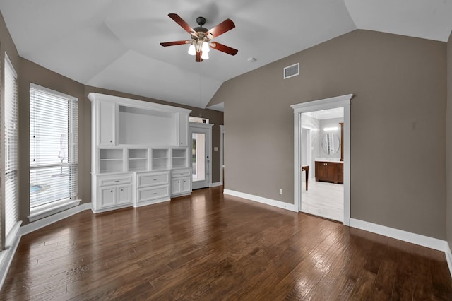19731 Stone Lake Dr, Tomball, TX 77377 - unfurnished bedroom featuring vaulted ceiling, dark wood-type flooring, baseboards, ensuite bath, and a ceiling fan