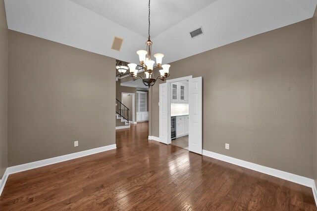 19731 Stone Lake Dr, Tomball, TX 77377 - unfurnished dining area with dark wood-type flooring, baseboards, vaulted ceiling, stairway, and a chandelier