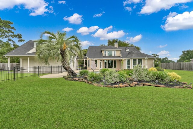 19731 Stone Lake Dr, Tomball, TX 77377 - back of house featuring a patio, a chimney, a garage, and stucco siding