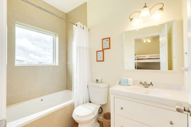 bathroom with vanity, toilet, ceiling fan, and shower / bath combo with shower curtain