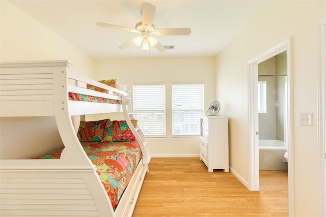 bedroom with baseboards, a ceiling fan, light wood finished floors, and visible vents