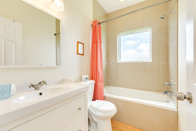 bathroom with vanity, toilet, wood finished floors, and shower / tub combo with curtain