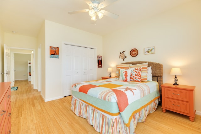 bedroom with a closet, a ceiling fan, light wood finished floors, and baseboards