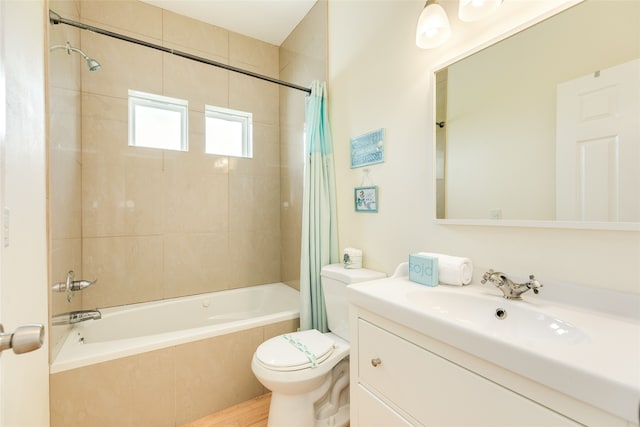 full bath with toilet, tiled shower / bath, wood finished floors, and vanity