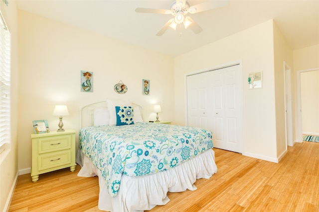 bedroom featuring baseboards, light wood-style flooring, and a closet