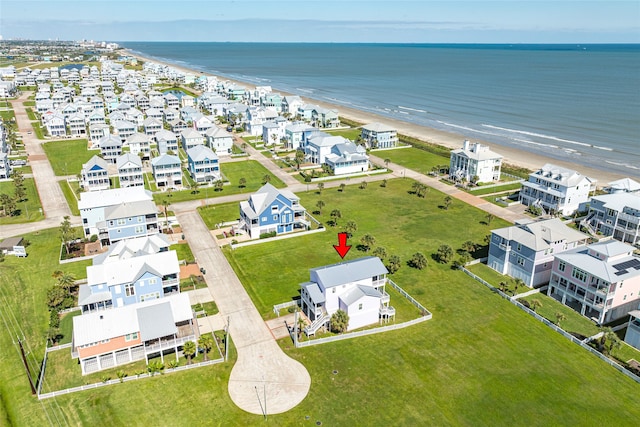 drone / aerial view with a beach view and a water view