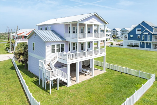 back of property with a fenced backyard, a patio, stairs, and a balcony