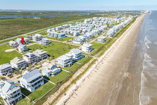 birds eye view of property featuring a view of the beach and a water view