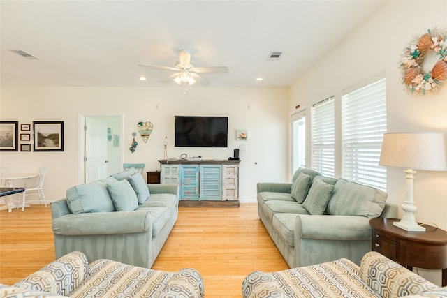 living room featuring a ceiling fan, visible vents, light wood-style flooring, and recessed lighting