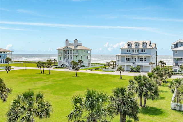 view of community with a lawn and a water view