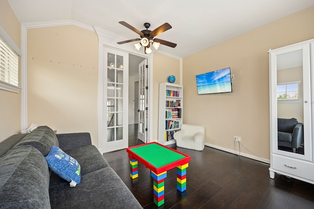 recreation room featuring a ceiling fan, french doors, wood finished floors, baseboards, and ornamental molding