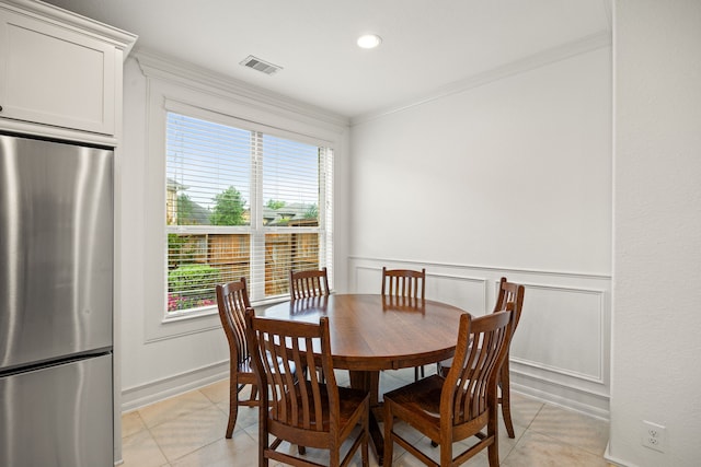 dining room featuring visible vents, light tile patterned flooring, and a wealth of natural light