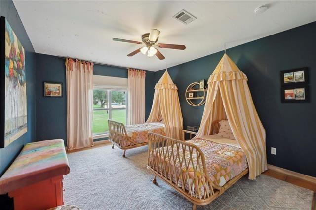 bedroom featuring a ceiling fan and visible vents