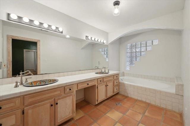 bathroom featuring double vanity, a bath, a sink, tile patterned floors, and a shower with door