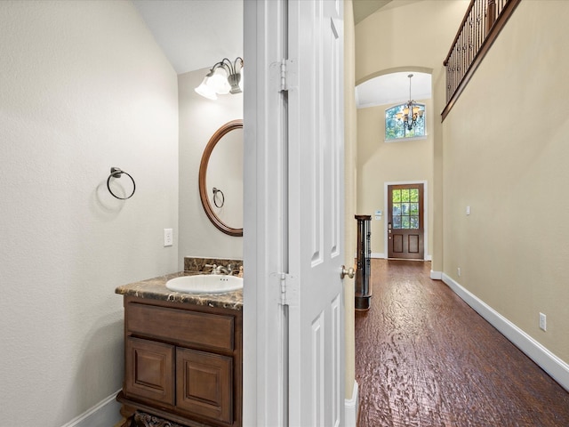 17306 Lake Chelan Ln, Humble, TX 77346 - bathroom with baseboards, a chandelier, wood finished floors, and vanity
