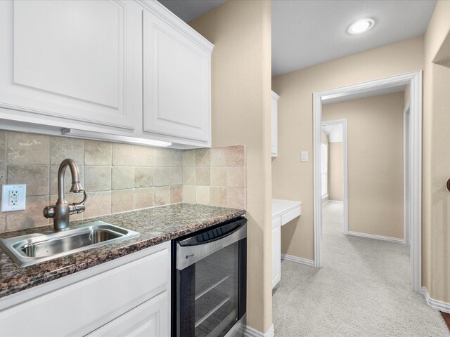 17306 Lake Chelan Ln, Humble, TX 77346 - kitchen featuring light colored carpet, a sink, white cabinetry, and wine cooler