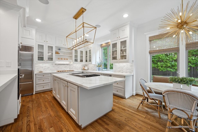 4122 University Blvd, Houston, TX 77005 - kitchen with white cabinets, stainless steel appliances, a chandelier, and a healthy amount of sunlight