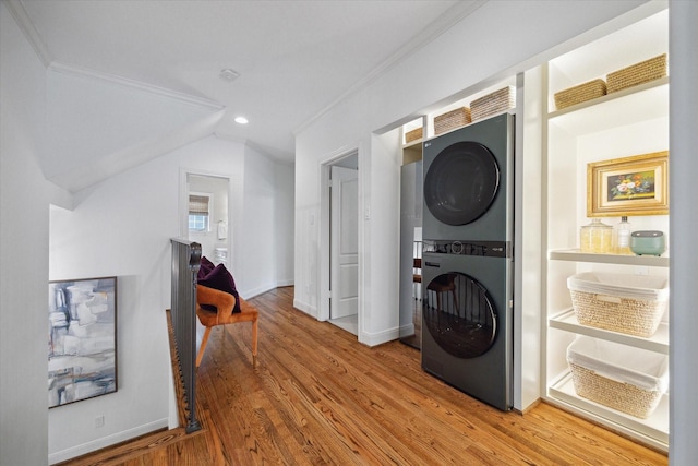 4122 University Blvd, Houston, TX 77005 - laundry area featuring crown molding, laundry area, recessed lighting, light wood-type flooring, and stacked washer and clothes dryer