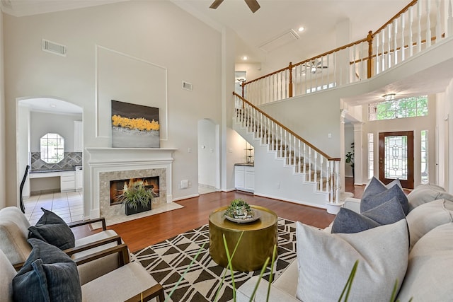 4319 Island Hills Dr, Pasadena, TX 77059 - living area with high vaulted ceiling, wood finished floors, stairway, arched walkways, and recessed lighting