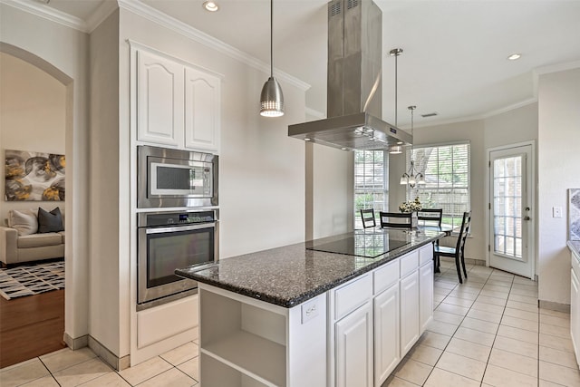 kitchen with open shelves, island range hood, white cabinetry, arched walkways, and appliances with stainless steel finishes