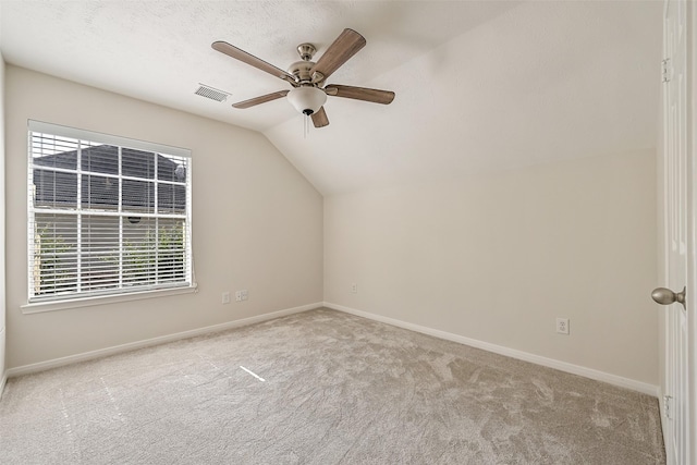 bonus room featuring ceiling fan, carpet, baseboards, lofted ceiling, and visible vents