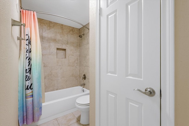 bathroom with shower / tub combo with curtain, tile patterned floors, and toilet